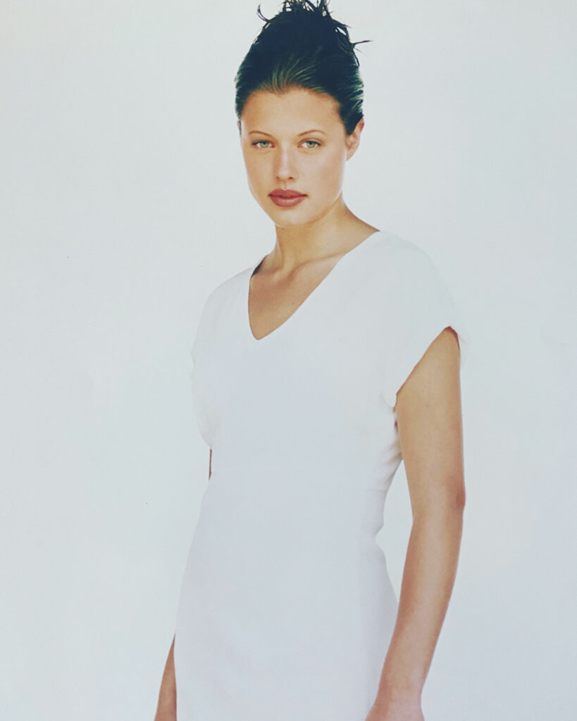 young Courtney in a white v neck dress